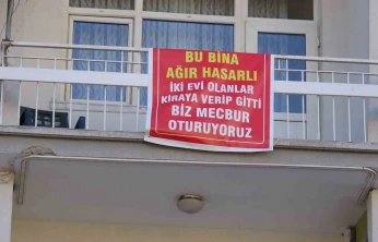 Ağır hasarlı pankartı asılan binayı görenler bir daha bakıyor