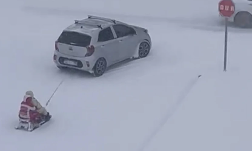 Kızağı araca bağlayıp çektiler, tehlikeli eğlence kameraya yansıdı